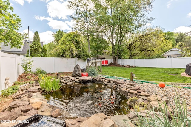 view of yard featuring a garden pond