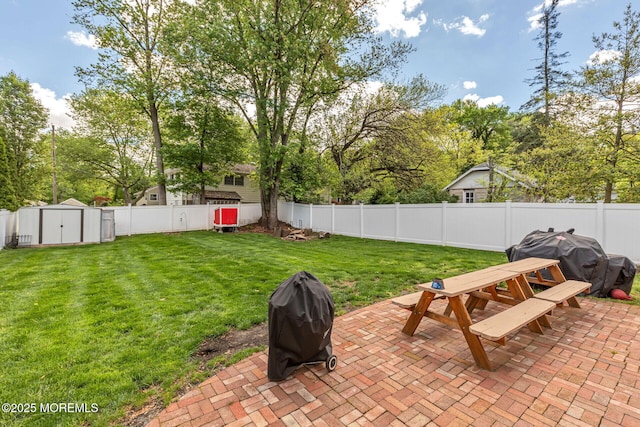 view of yard with a patio, outdoor dining space, a storage shed, and an outdoor structure