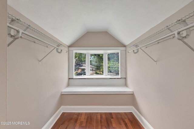 walk in closet featuring lofted ceiling and wood finished floors