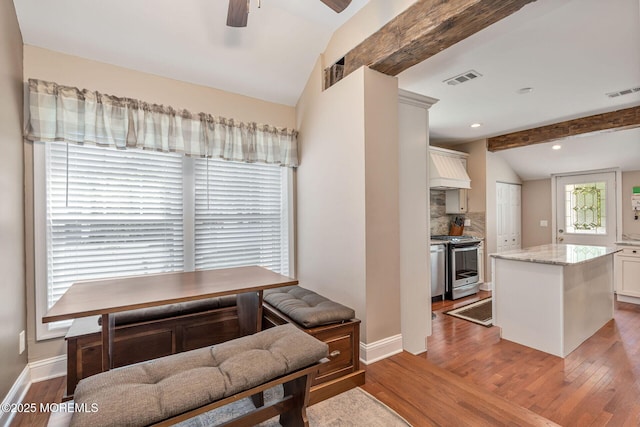 dining area featuring wood finished floors, ceiling fan, and baseboards