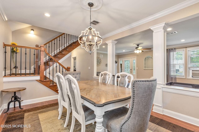 dining space with decorative columns, wood finished floors, ceiling fan, healthy amount of natural light, and ornamental molding