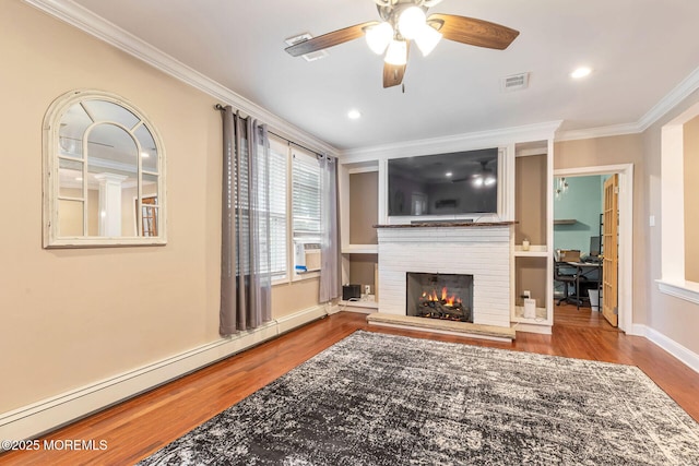living room with a baseboard radiator, crown molding, wood finished floors, ceiling fan, and a fireplace