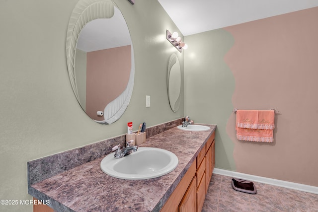 full bathroom featuring double vanity, baseboards, and tile patterned floors