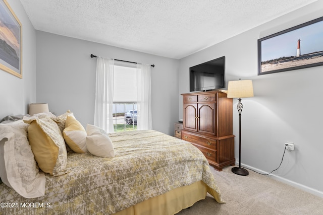 bedroom featuring carpet floors, a textured ceiling, and baseboards