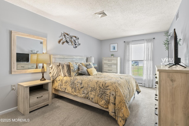 bedroom featuring carpet floors and a textured ceiling