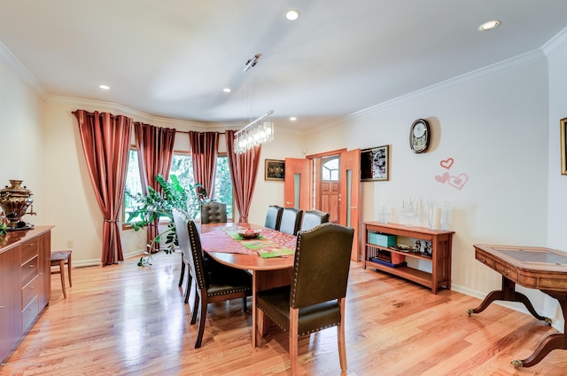 dining area with ornamental molding, light wood finished floors, baseboards, and recessed lighting