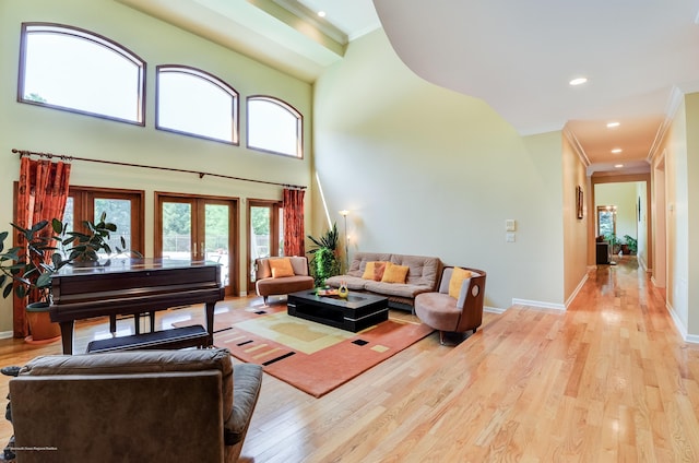 living area with crown molding, light wood-type flooring, french doors, baseboards, and recessed lighting