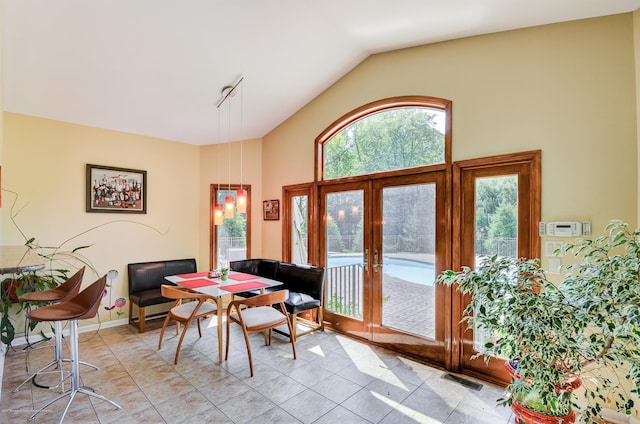 dining room featuring french doors and high vaulted ceiling