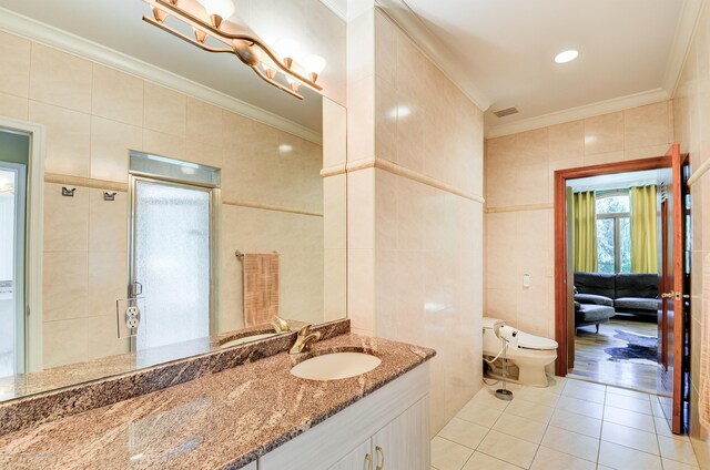 full bathroom featuring tile walls, tile patterned flooring, crown molding, toilet, and a shower stall