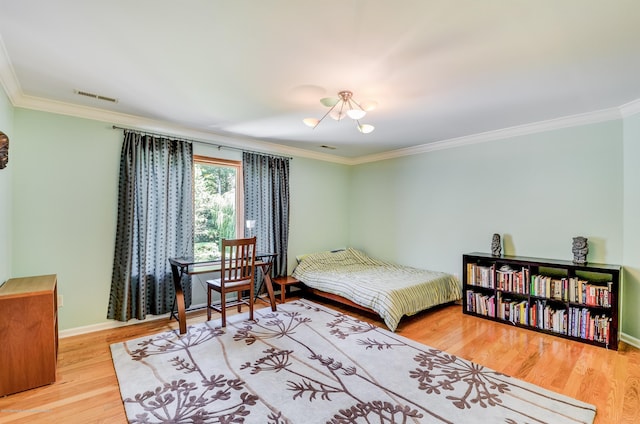 bedroom with ornamental molding, a chandelier, wood finished floors, and baseboards