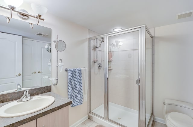 bathroom featuring toilet, a stall shower, baseboards, and vanity