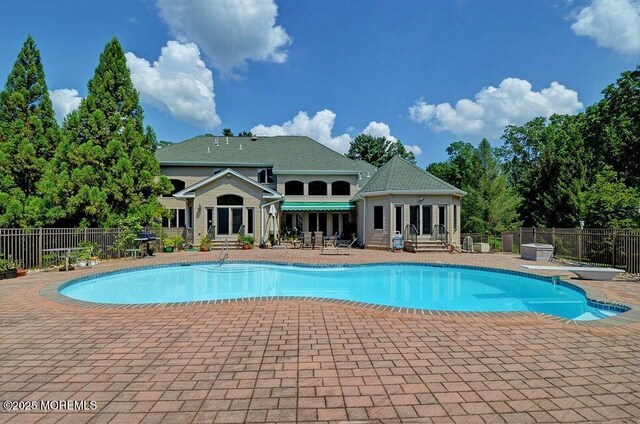 view of swimming pool featuring a patio, fence, and entry steps