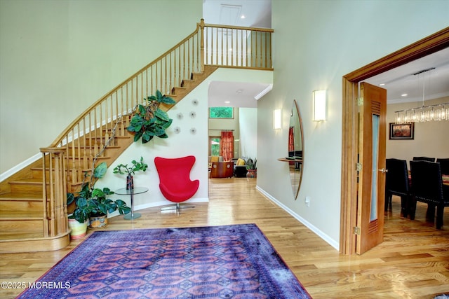 7 Mccampbell Rd, Holmdel, NJ 07733 - entryway featuring wood finished floors, stairway, a high ceiling, baseboards, and a chandelier