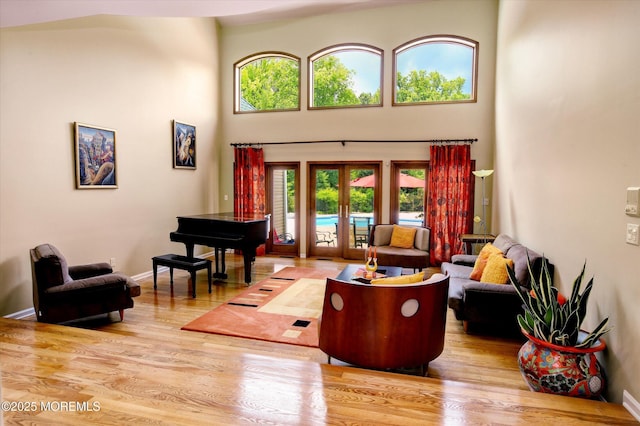 7 Mccampbell Rd, Holmdel, NJ 07733 - living room featuring french doors, wood finished floors, plenty of natural light, a towering ceiling, and baseboards