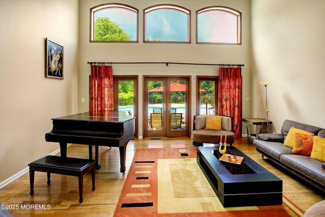 7 Mccampbell Rd, Holmdel, NJ 07733 - living room featuring french doors, a towering ceiling, plenty of natural light, and light wood finished floors