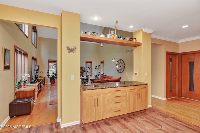 7 Mccampbell Rd, Holmdel, NJ 07733 - kitchen with light brown cabinets, light wood finished floors, dark stone counters, baseboards, and ornamental molding