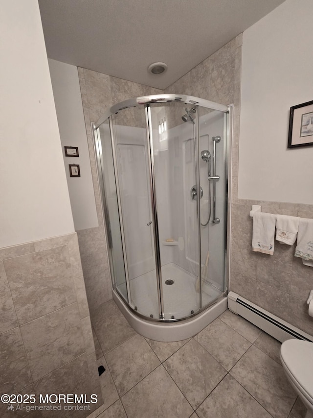 804 Brookside Dr, Toms River, NJ 08753 - bathroom with tile walls, a stall shower, wainscoting, toilet, and tile patterned floors