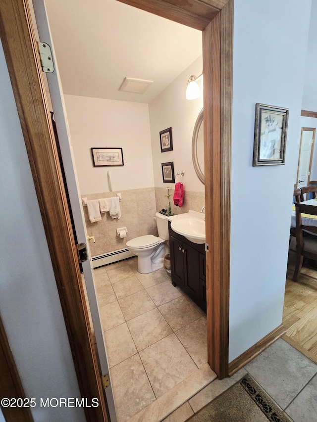 804 Brookside Dr, Toms River, NJ 08753 - bathroom with a baseboard heating unit, tile patterned flooring, vanity, toilet, and tile walls