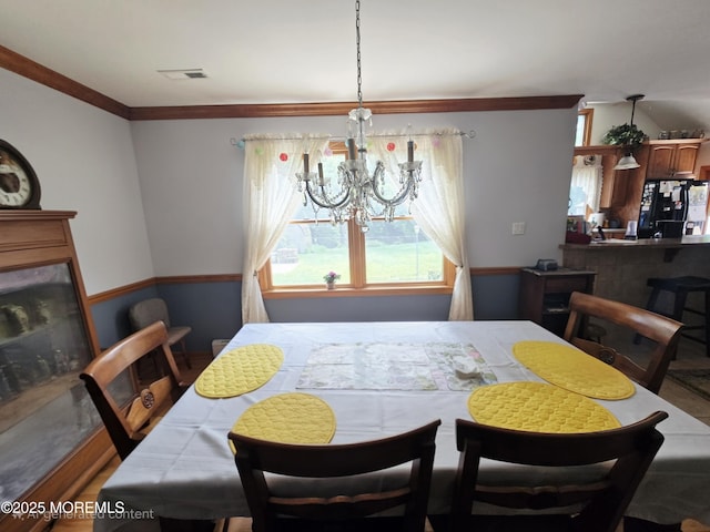 804 Brookside Dr, Toms River, NJ 08753 - dining space featuring crown molding and a chandelier