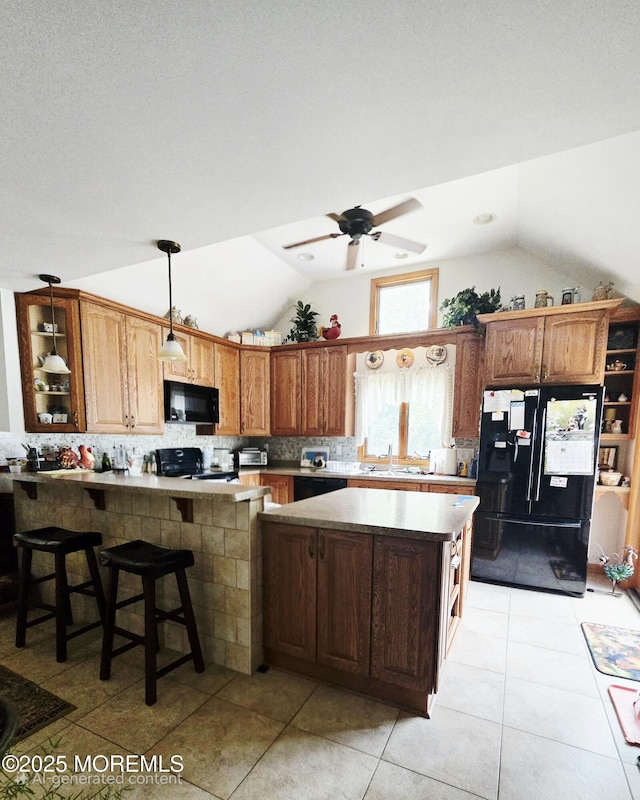 804 Brookside Dr, Toms River, NJ 08753 - kitchen with black appliances, lofted ceiling, a sink, decorative backsplash, and pendant lighting