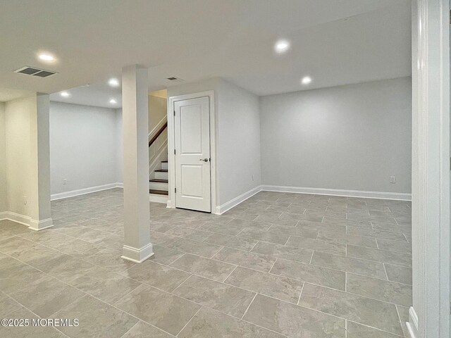 finished basement with recessed lighting, stairs, baseboards, and light tile patterned floors