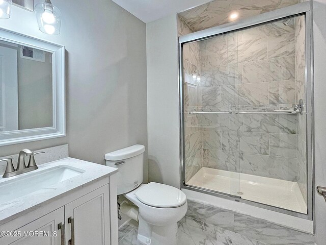 bathroom featuring marble look tiles, a stall shower, toilet, and vanity