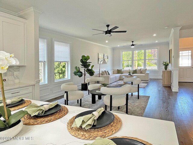 living room featuring ornamental molding, dark wood-style flooring, ceiling fan, recessed lighting, and a decorative wall