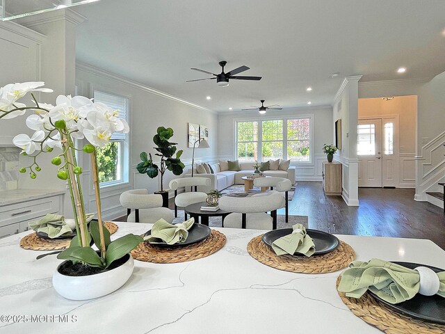 living area featuring plenty of natural light, crown molding, dark wood-style floors, recessed lighting, and a ceiling fan