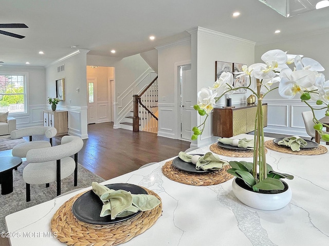 living area featuring a decorative wall, crown molding, stairway, recessed lighting, and ceiling fan