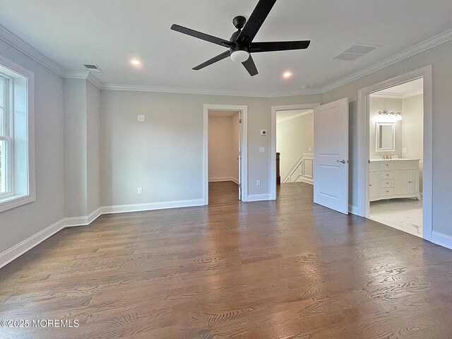 unfurnished bedroom with baseboards, wood finished floors, ornamental molding, recessed lighting, and ensuite bathroom