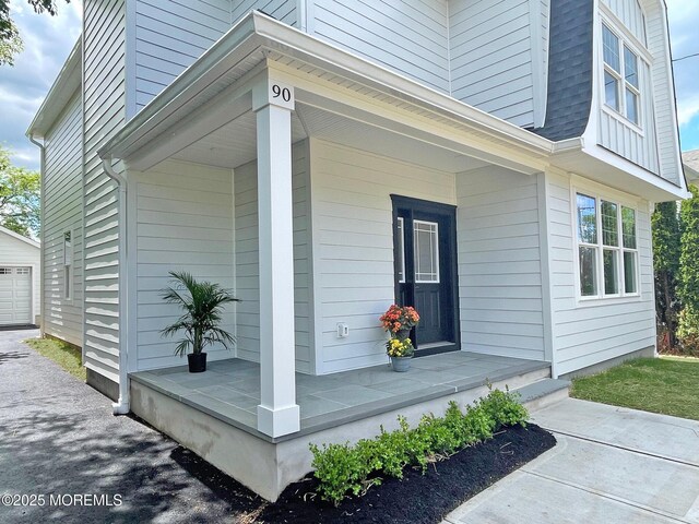 view of home's exterior featuring covered porch, a garage, and an outdoor structure