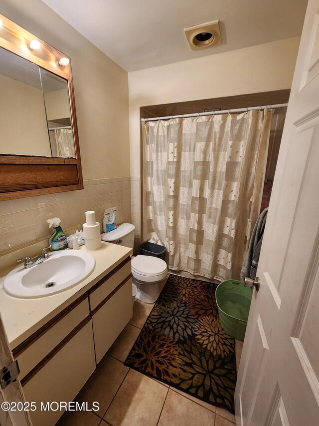 1102 Sawmill Rd Unit 99, Brick, NJ 08724 - full bathroom featuring toilet, tile patterned floors, vanity, tile walls, and a wainscoted wall