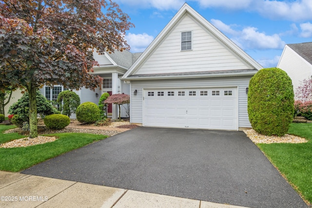 traditional-style house with asphalt driveway and a garage