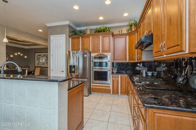 kitchen featuring appliances with stainless steel finishes, under cabinet range hood, brown cabinetry, crown molding, and light tile patterned flooring