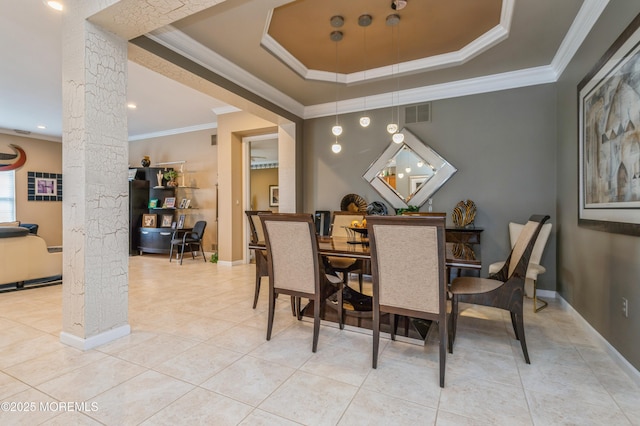 dining space with ornate columns, light tile patterned floors, a raised ceiling, crown molding, and baseboards