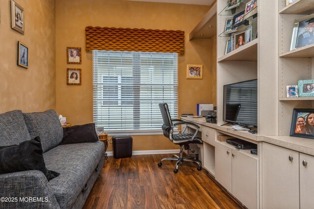 office space with dark wood-type flooring, baseboards, and built in study area