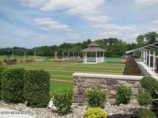 surrounding community with a gazebo, a lawn, and a bocce ball area