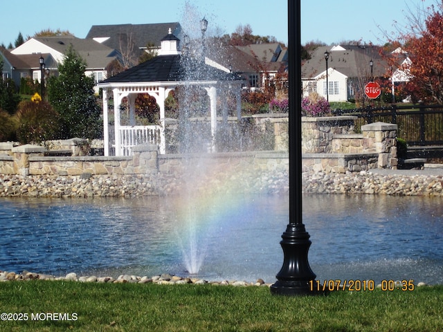 water view with a gazebo and fence