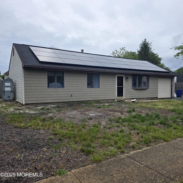 56 Georgetown Blvd, Barnegat, NJ 08005 - single story home with roof mounted solar panels, a shingled roof, and an attached garage