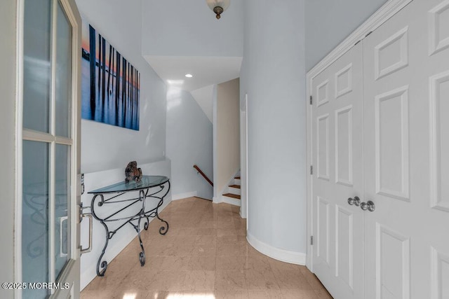 hall with baseboards and recessed lighting