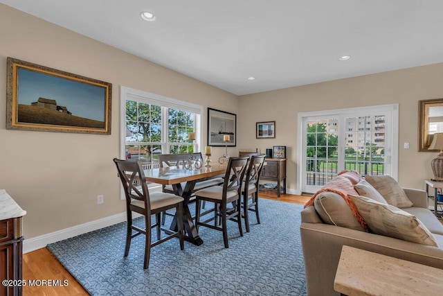 dining room featuring wood finished floors, baseboards, and recessed lighting