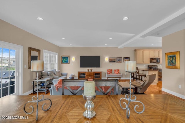 dining area with baseboards, wood finished floors, recessed lighting, and beamed ceiling