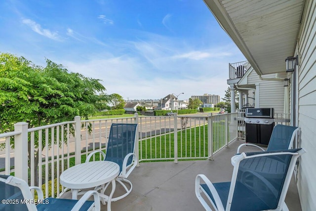 view of patio featuring a balcony and a grill