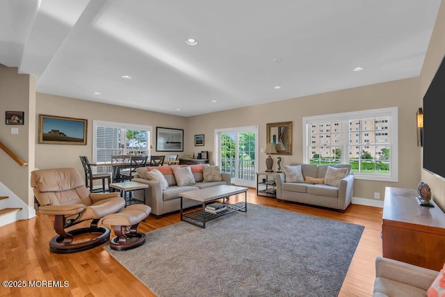 living area featuring wood finished floors, stairway, recessed lighting, and baseboards