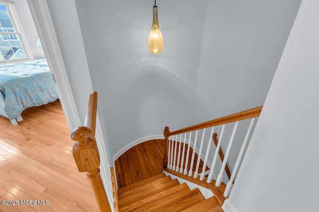stairway with wood finished floors