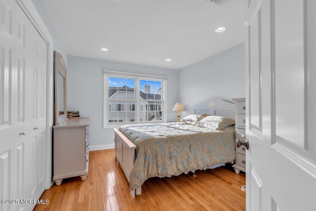 bedroom featuring light wood-style flooring, a closet, baseboards, and recessed lighting