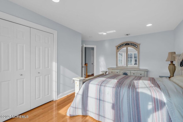 bedroom featuring light wood finished floors, a closet, recessed lighting, and baseboards