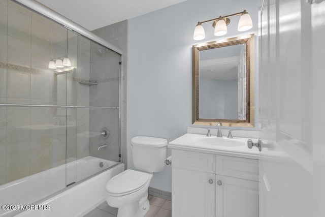 bathroom featuring toilet, vanity, shower / bath combination with glass door, and tile patterned flooring