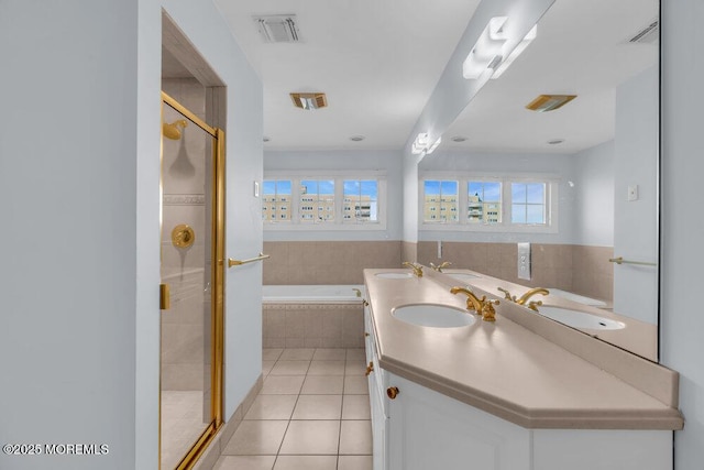 full bathroom with tile patterned floors, a shower stall, a bath, and double vanity