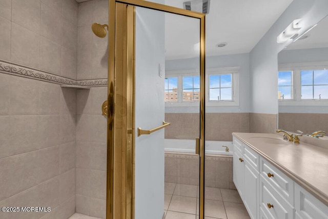 full bath with tile patterned floors, a bath, vanity, and a tile shower